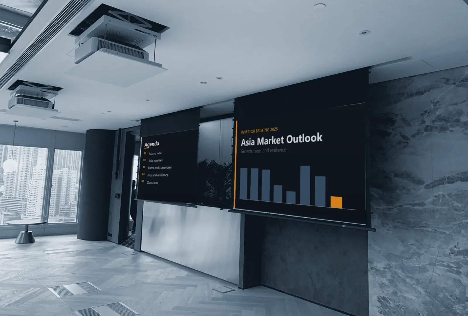 An event space with two drop-down projection screens and ceiling projectors