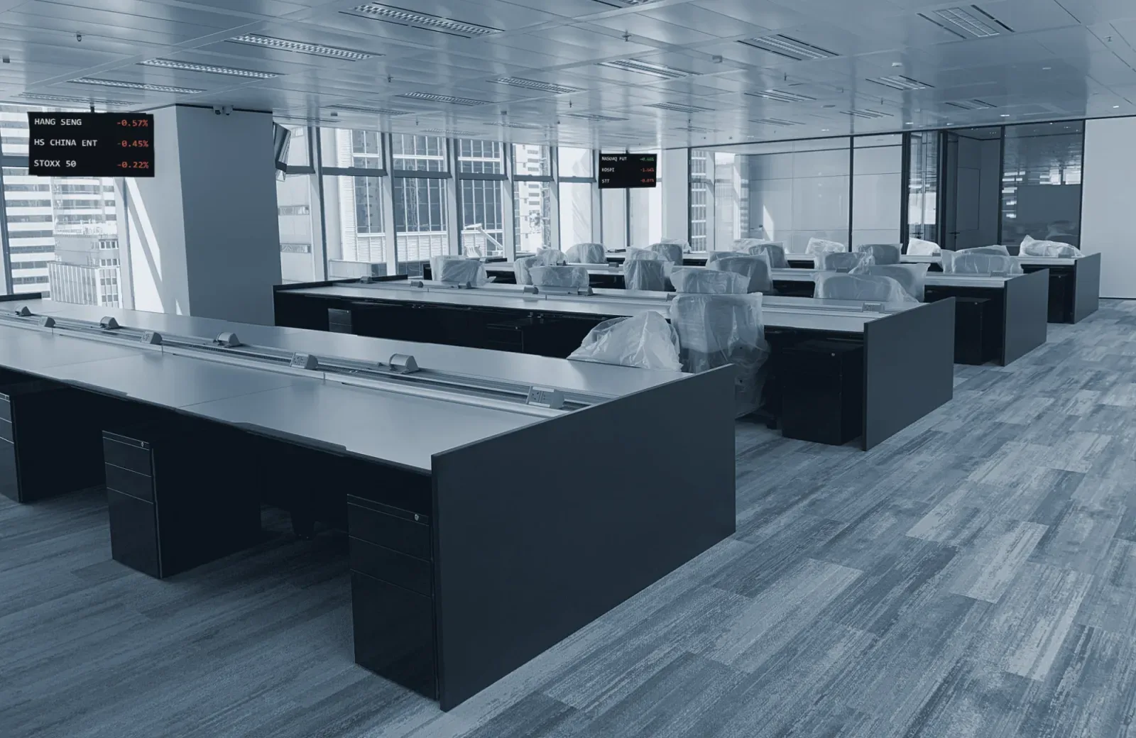 Rows of bench desks with wall screens on a new office floor